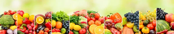 Healthy fruits, vegetables and berries on green blurred background.