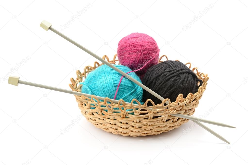 Multicolored balls and needles in basket