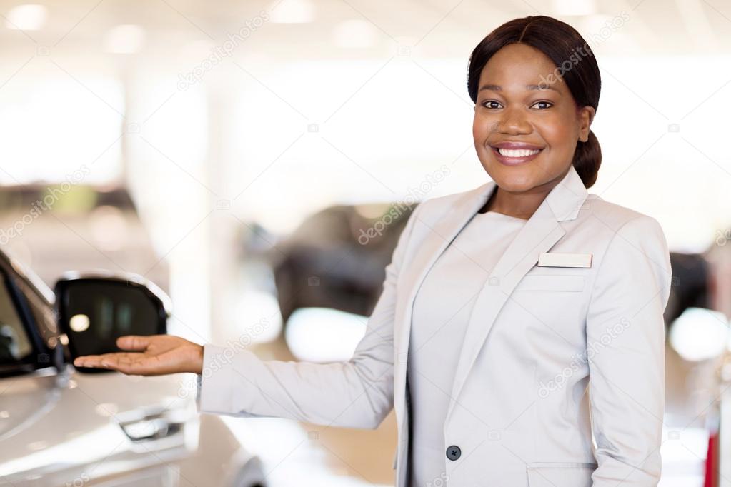 car saleswoman presenting new vehicle