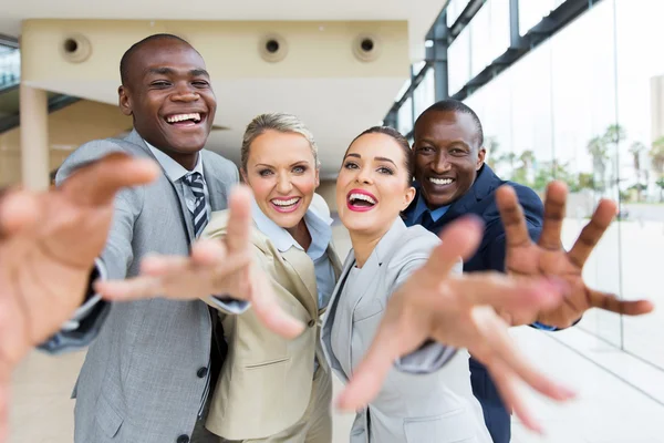 Business people reaching for camera by hands — Stock Photo, Image