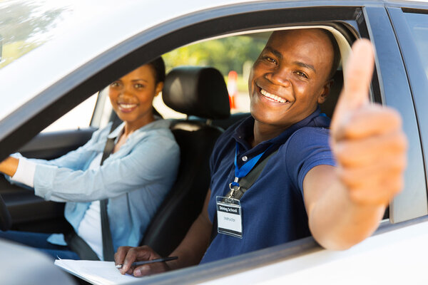 Driving instructor giving thumb up