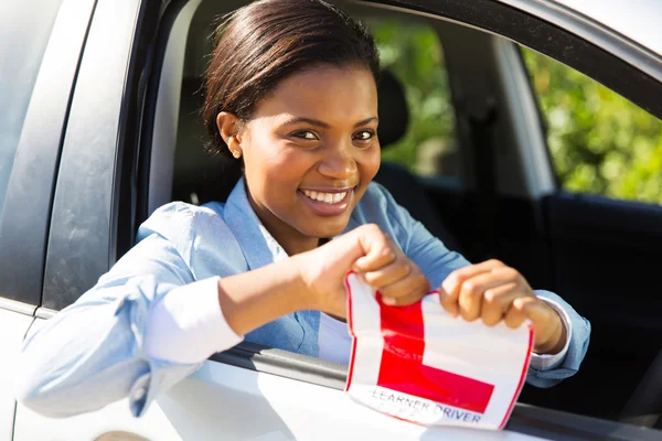 Menina em um carro rasgando seu sinal L — Fotografia de Stock