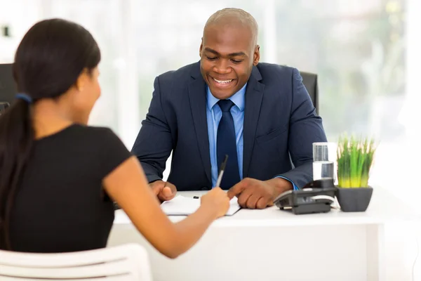 African woman signing employment contract — Stock Photo, Image