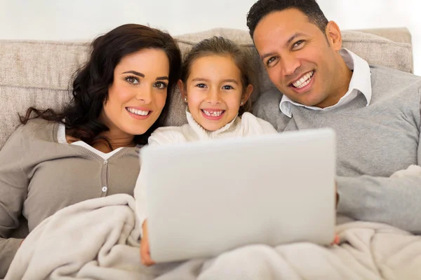 Family of three using laptop — Stock Photo, Image