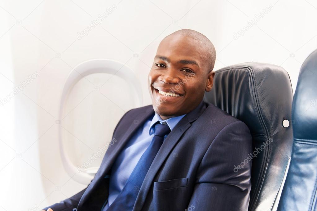 African-american airplane passenger relaxing