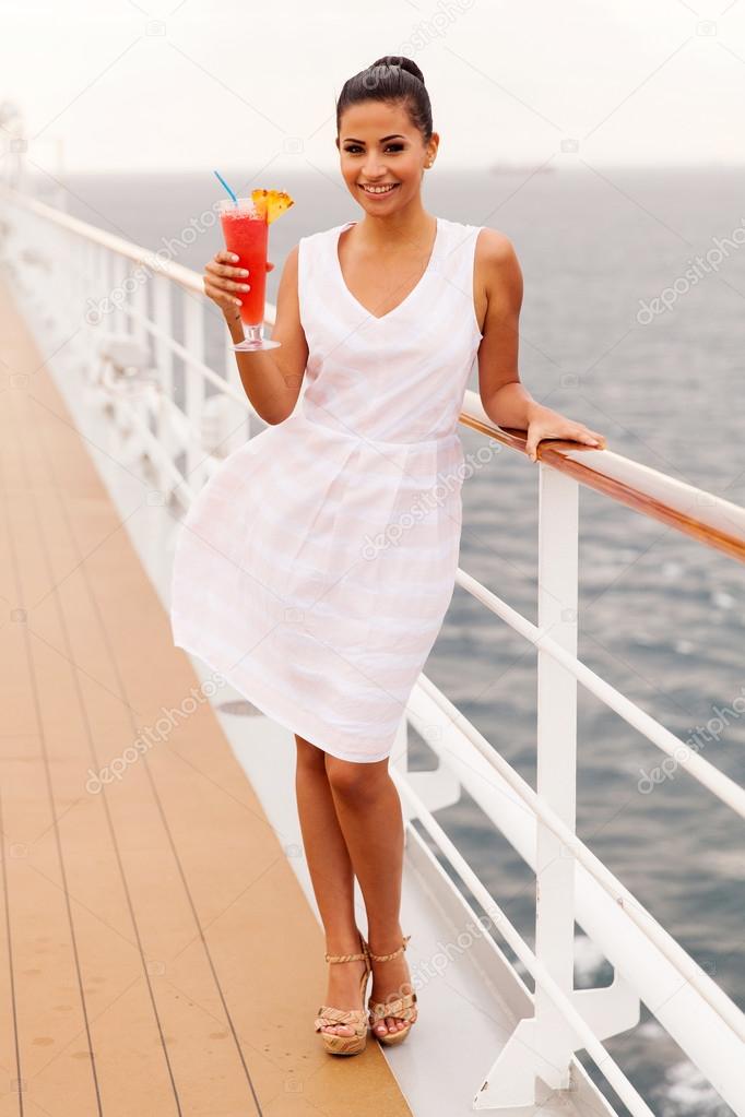 Woman drinking cocktail on cruise