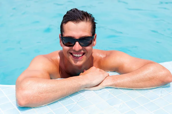 Man relaxing in swimming pool