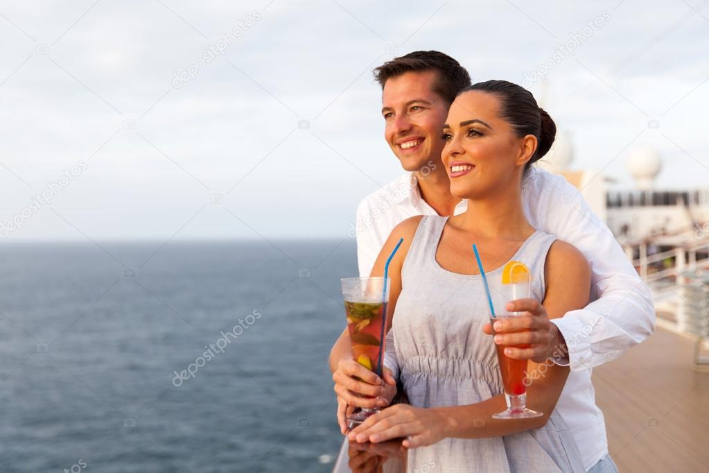 Couple on cruise holding cocktails