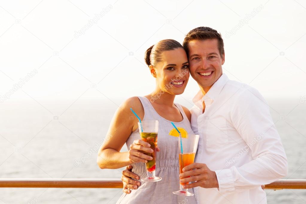 Couple on cruise holding cocktails