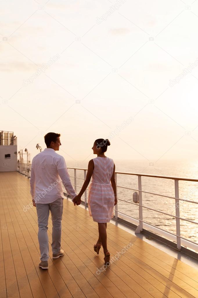 Couple holding hands on cruise ship