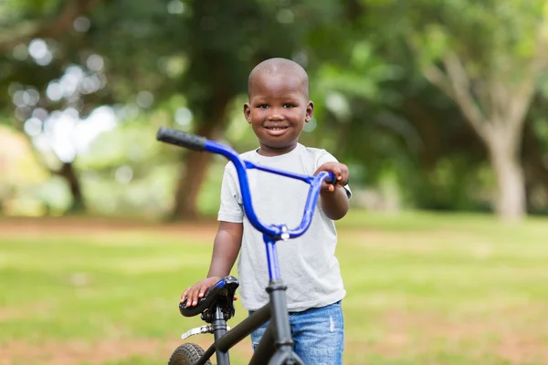 Jongen met zijn fiets buitenshuis — Stockfoto