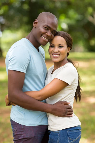 African couple smiling outdoors — Stock Photo, Image