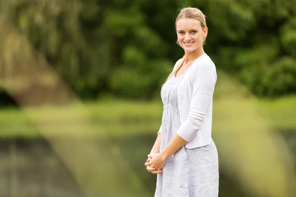 Joven mujer de pie junto al lago —  Fotos de Stock