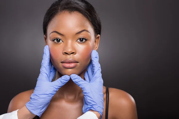 Plastic surgeon checking woman face — Stock Photo, Image