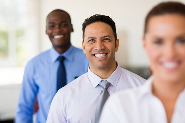 middle aged businessman standing in a row