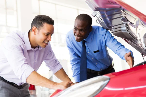 Consultor de vendas e cliente olhando para um motor de carro — Fotografia de Stock