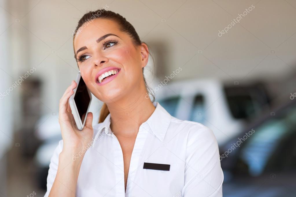 car saleswoman talking on cell phone