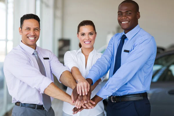 Car dearship staff putting their hands together — Stock Photo, Image