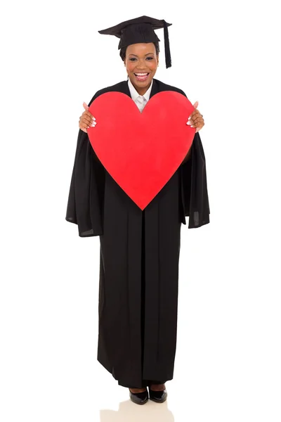 College graduate holding heart shape — Stock Photo, Image