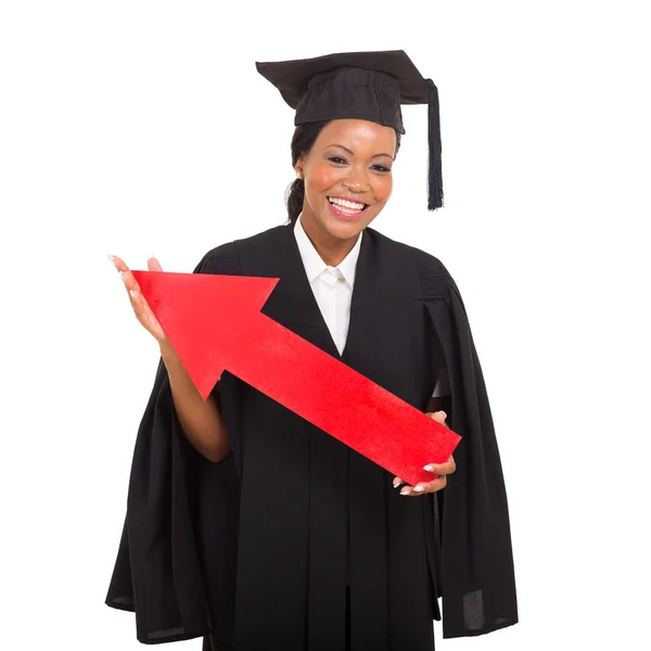 Graduação faculdade segurando seta vermelha — Fotografia de Stock
