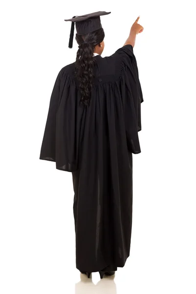 Rear view of female graduate pointing — Stock Photo, Image