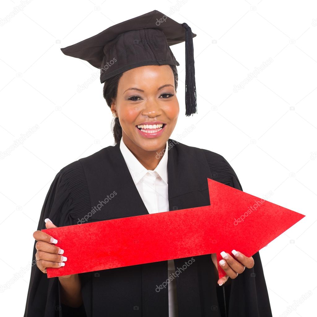 Female graduate holding direction arrow