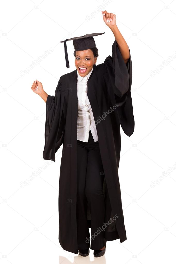 College student in graduation gown dancing