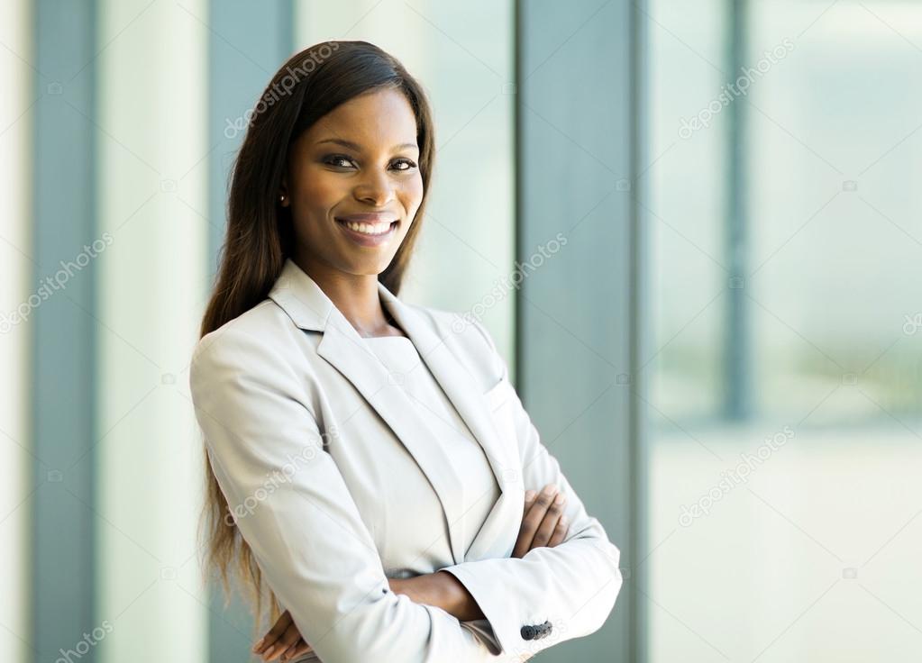 Business woman with arms crossed in office