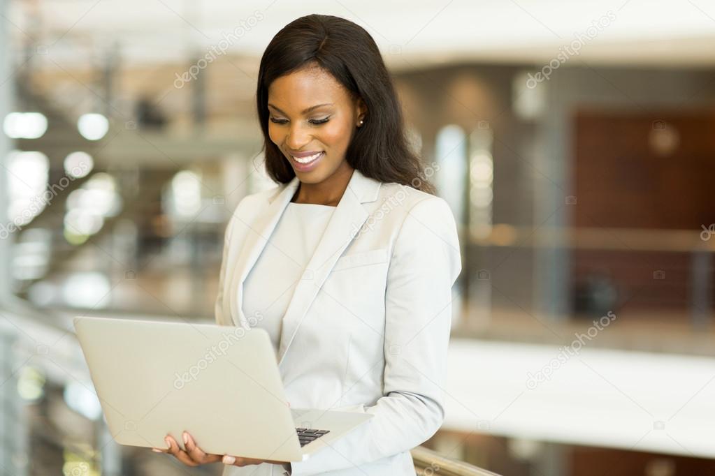 black businesswoman working on laptop in office