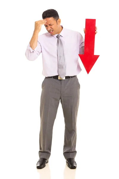 Businessman holding arrow pointing down — Stock Photo, Image