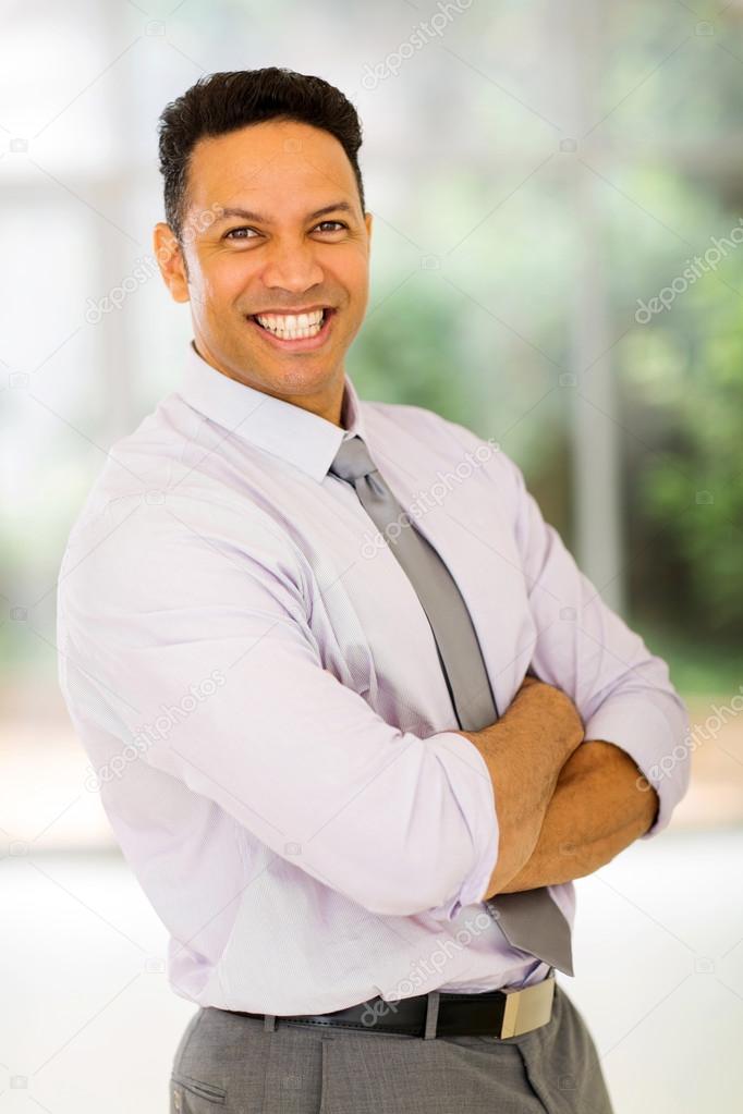businessman with arms crossed in office
