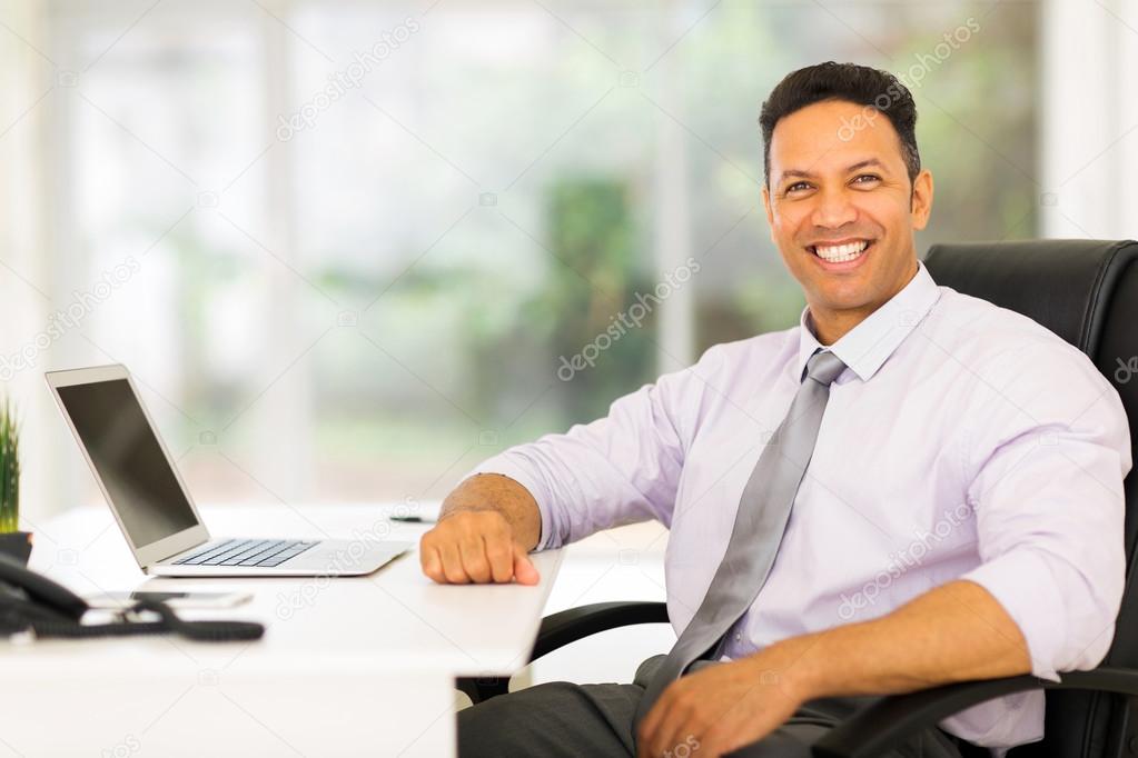 middle aged businessman sitting in office