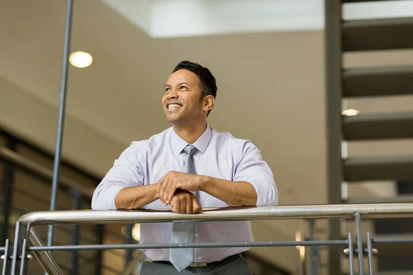 Businessman looking up in office — Stock Photo, Image