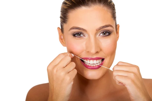 Woman using dental floss — Stock Photo, Image