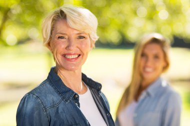 woman standing in front of daughter clipart