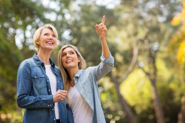 Daughter taking mother for walk — Stockfoto