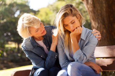 woman comforting her sad daughter
