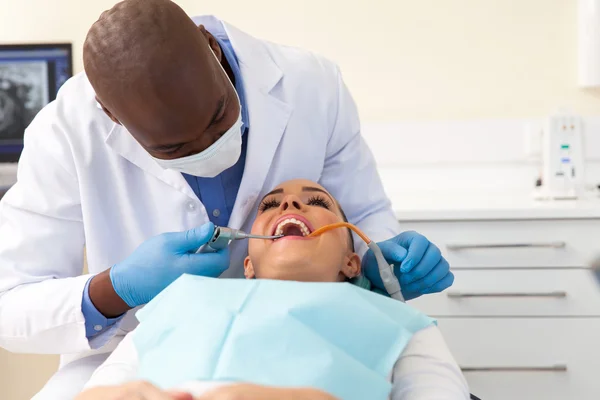 Patient having her teeth cleaned — Stok fotoğraf