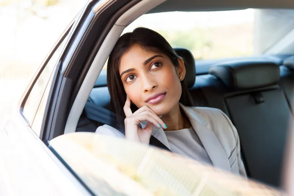 Young indian businesswoman in a taxi — Stock Photo, Image