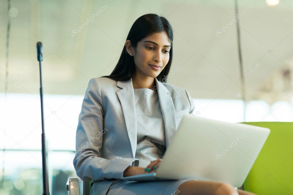 traveler using laptop at airport