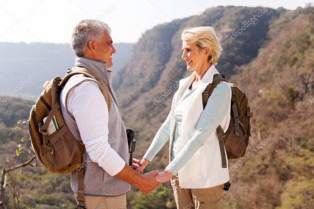 couple holding hands in mountain