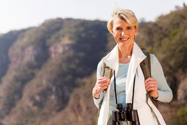 woman on mountain with binoculars