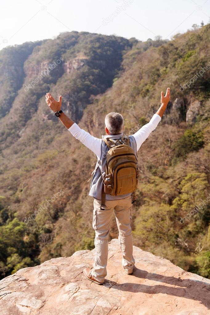 male hiker with arms open