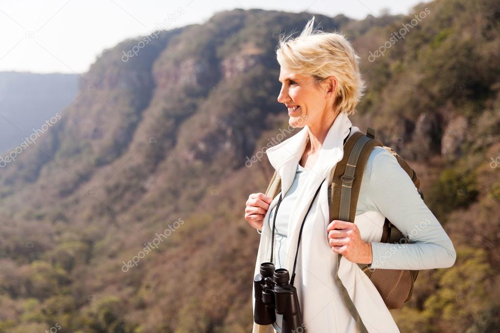 woman on mountain with binoculars