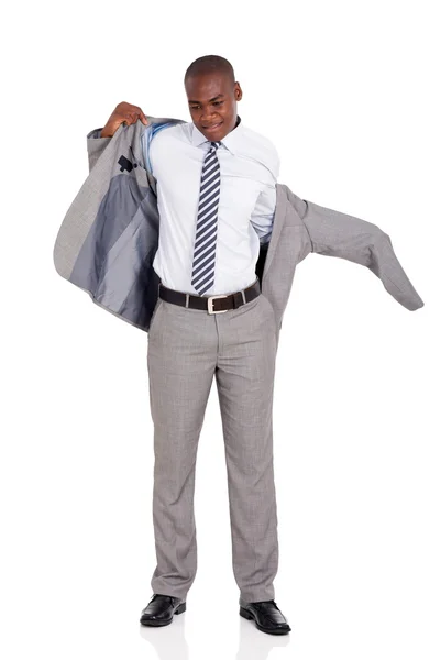 Businessman putting on suit jacket — Stock Photo, Image