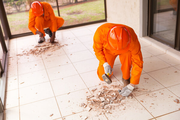 builders removing old floor tiles