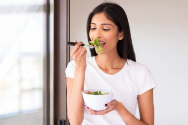 Yeşil salata yiyen kadın