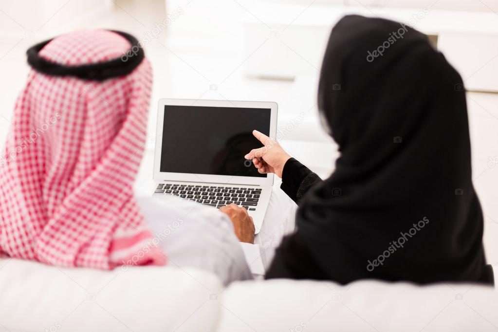 muslim couple using laptop computer