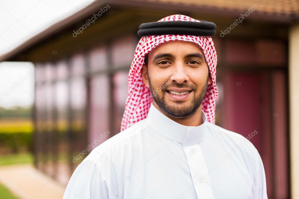 arabian man standing near house