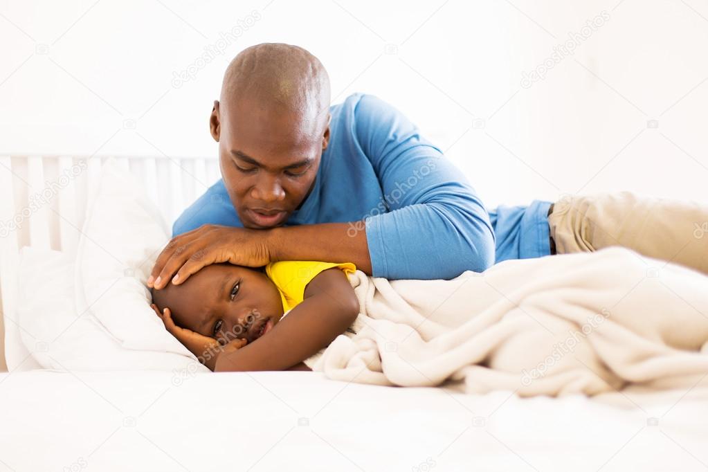 father taking care of ill son